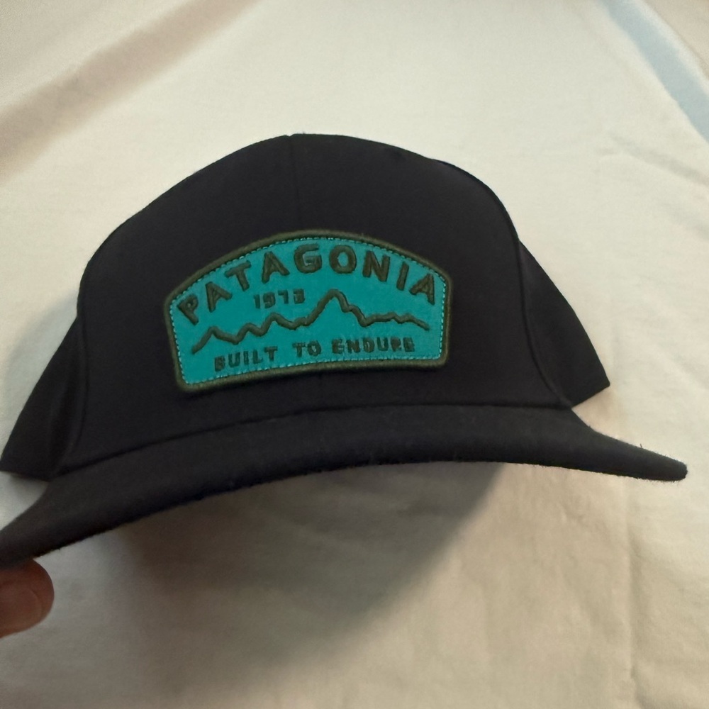 Patagonia Black Hat with Teal Patch
Roger that - built to endure snap back